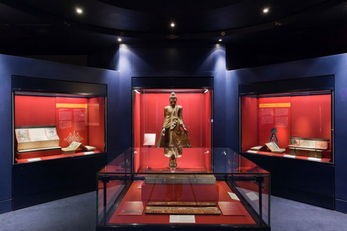 Statue, books and parchments on display