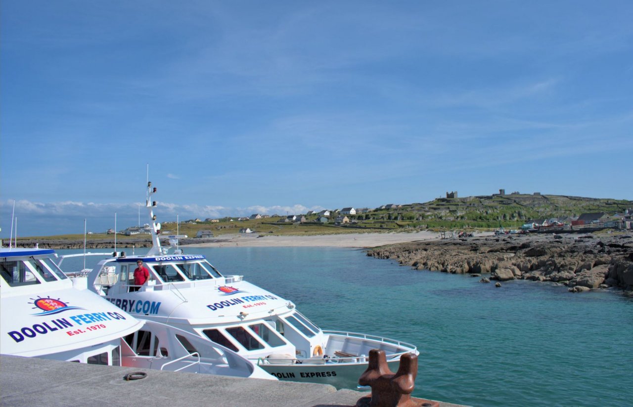 Doolin Ferries Boats at the Pier with the Inis Oirr Beach and the Castle at the Background