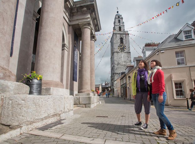 A couple on a tour with Shandon Bells Tower in the Background