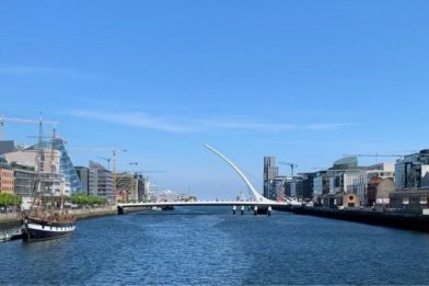 View of Dublin city from the river Liffey with the Jeanie Johnston and the Samuel Beckett bridge in the background