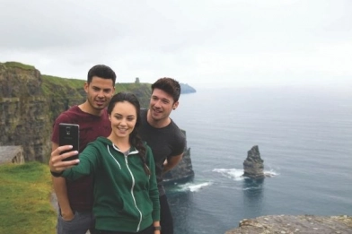 Students out in the fresh air taking a picture in front of the Cliffs of Moher