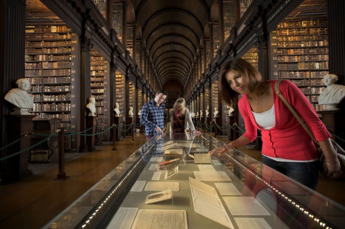 Visitors looking at the displays in the Long Room at Trinity College's Old Library