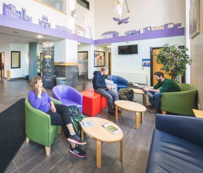 Three People in the Reception of the International Youth Hostel in Belfast