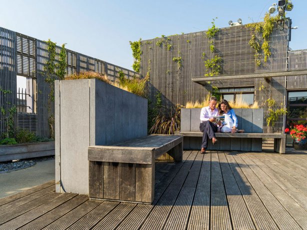 Couple reading on a bench on a terrace