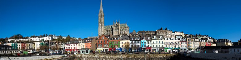 View of the Cathedral Church of St Colman and colourful houses from the sea - Cobh harbour