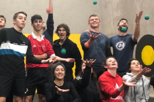 Group of students playing with balls in a sports venue