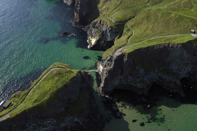 Green Clifftops Birds View of the Carrick-a-Rede Rope Bridge