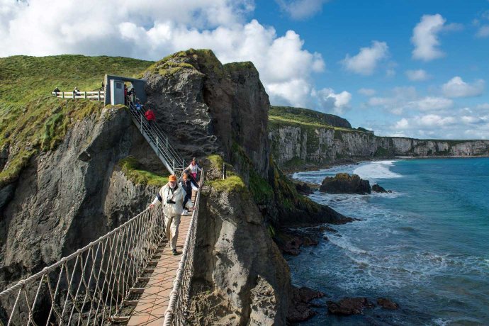 Visitors on The Rope Bridge Walking Off The Island Towards the Mainland 