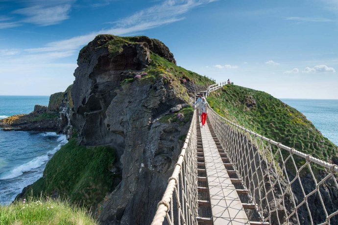 Tourists Walking Towards Island on the Rope Bridge in Co Antrim