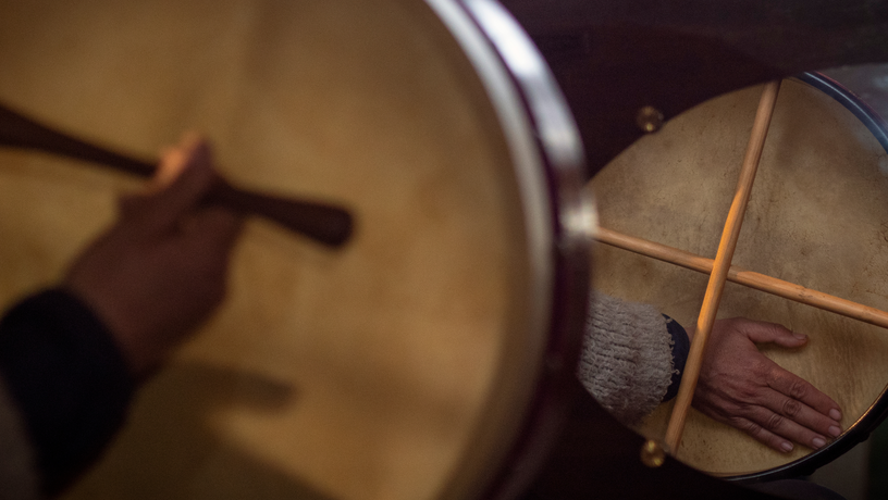 People playing traditional irish bodhran drum