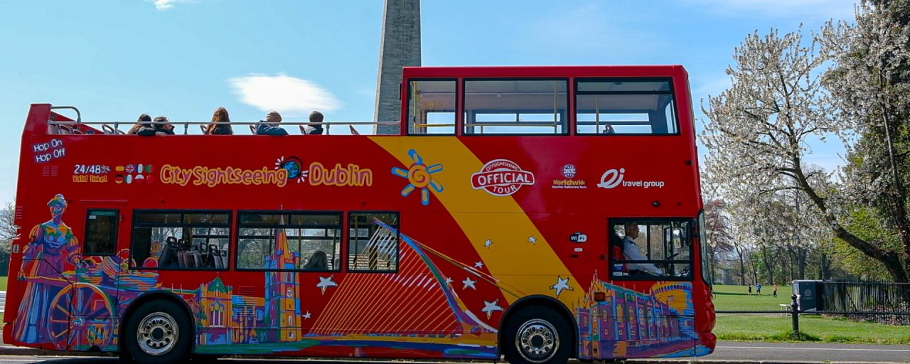 Red Open Top Double Decker Bus with City Sightseeing Logo On Site. Blue  Sky and Sunny Day