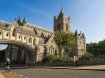 People walking and riding towards Christ Church Cathedral bridge