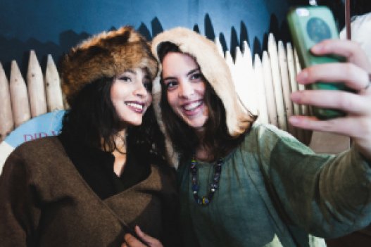 Two girls taking selfie dressed up as vikings 