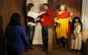 A man being chained by the neck by the tour guide