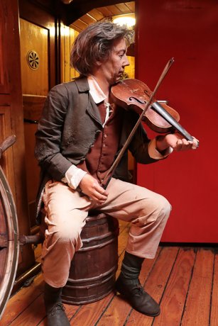 Immigrant playing the violin on a ship