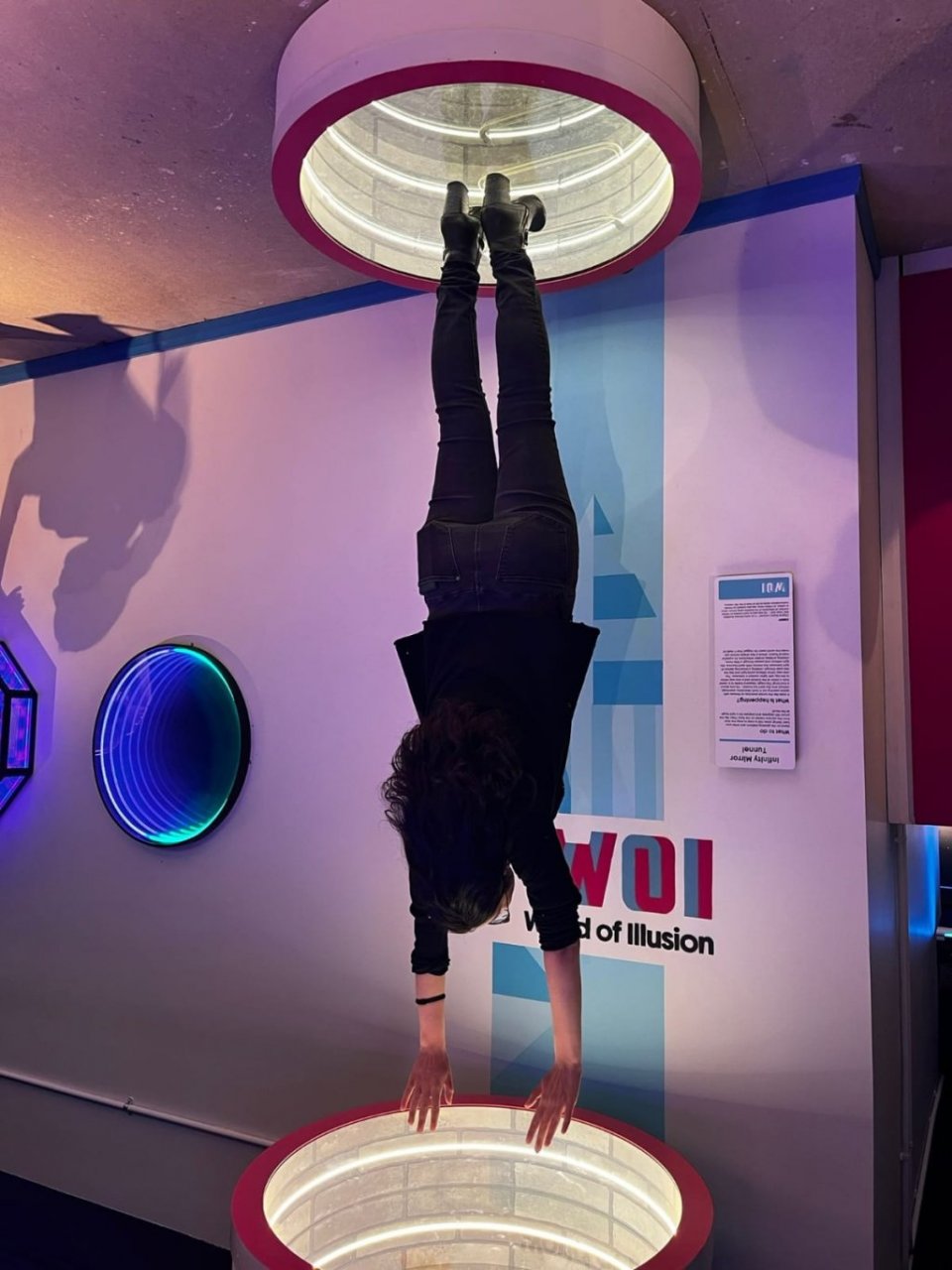 Student visiting WOI in Dublin is using Interactive eye tricking exhibit - Up-side-down Effects 