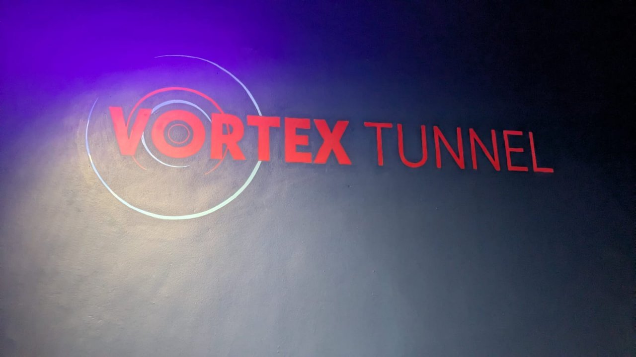 Logo of the Vortex Tunnel on the dark blue wall in World of Illusion in Dublin