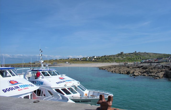 Doolin Ferries Boats at the Pier with the Inis Oirr Beach and the Castle at the Background