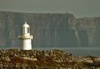 White Inis Oirr Lighthouse with the Cliffs of Moher Backdrop