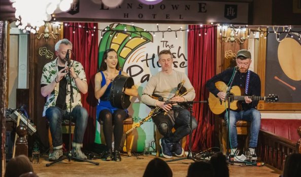 Artists performing on the stage - Irish House party logo in the Background