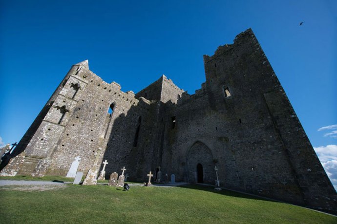 Tombstones under the tall castle walls