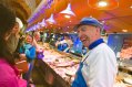 Friendly clerk laughing with customers