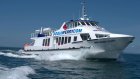 Doolin Express Ferry at sea at full speed with a large writing on a side of the cabin DoolinFerry.com