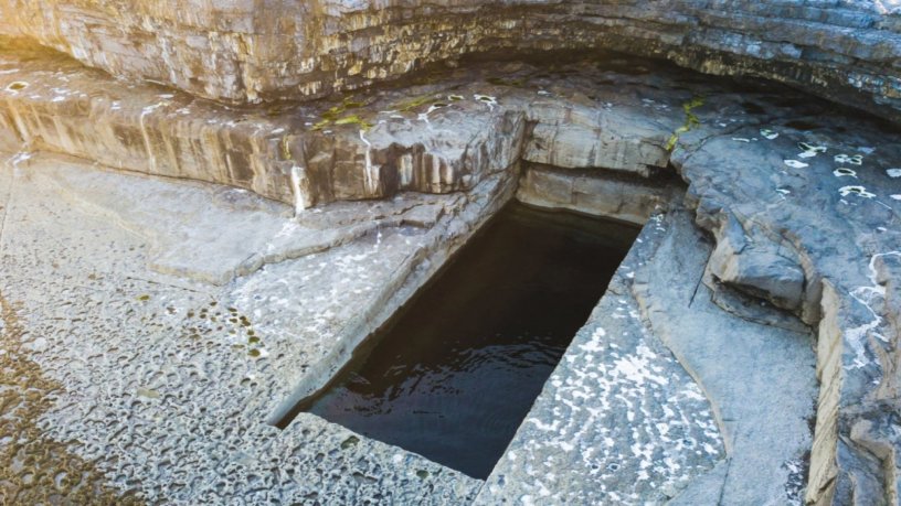 Natural rectangular shaped pool on a rocky coast