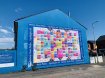 Painted Blue side of the terraced house with a giant Mural in West Belfast 