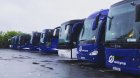 Fronts from angle of several buses parked on a car park ready for groups 