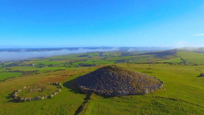 Aerial Loughcrew Cairn Tombs Ancient Mound on The Green Fields in Full Sunshine and Blue Sky
