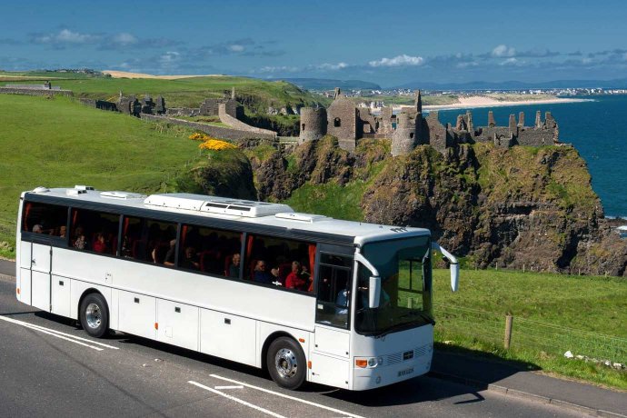 Bus Passing Dunluce Castle Popular Attraction for Group Tours