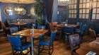 restaurant sitting area with blue chairs, brown tables, blue walls. Suitable for group meals in Dublin centre
