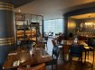 Group dinning space with Square brown tables brown chairs, brown walls. For groups staying in Dublin city hostels