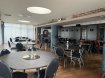 restaurant area with blue circular tables, blue chairs, blue walls and white ceiling.  Special group rates for meals