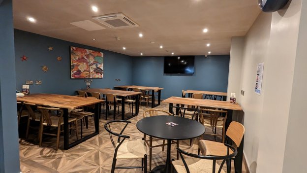 Dining Area with tables, chairs and TV screenHostel Restaurant For Groups in Dublin