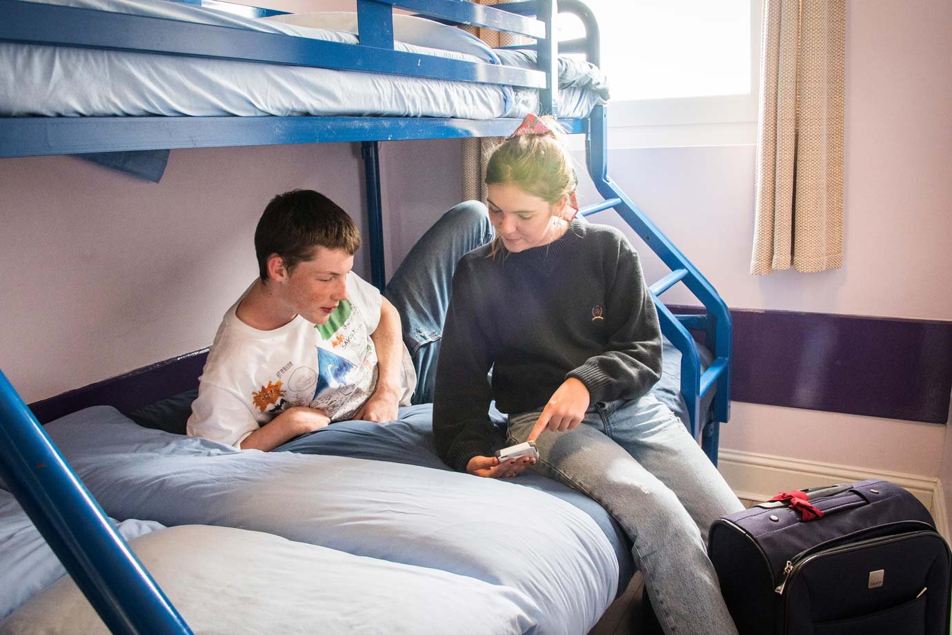 Students Resting in the Hostel Room on a Bunk Bad 