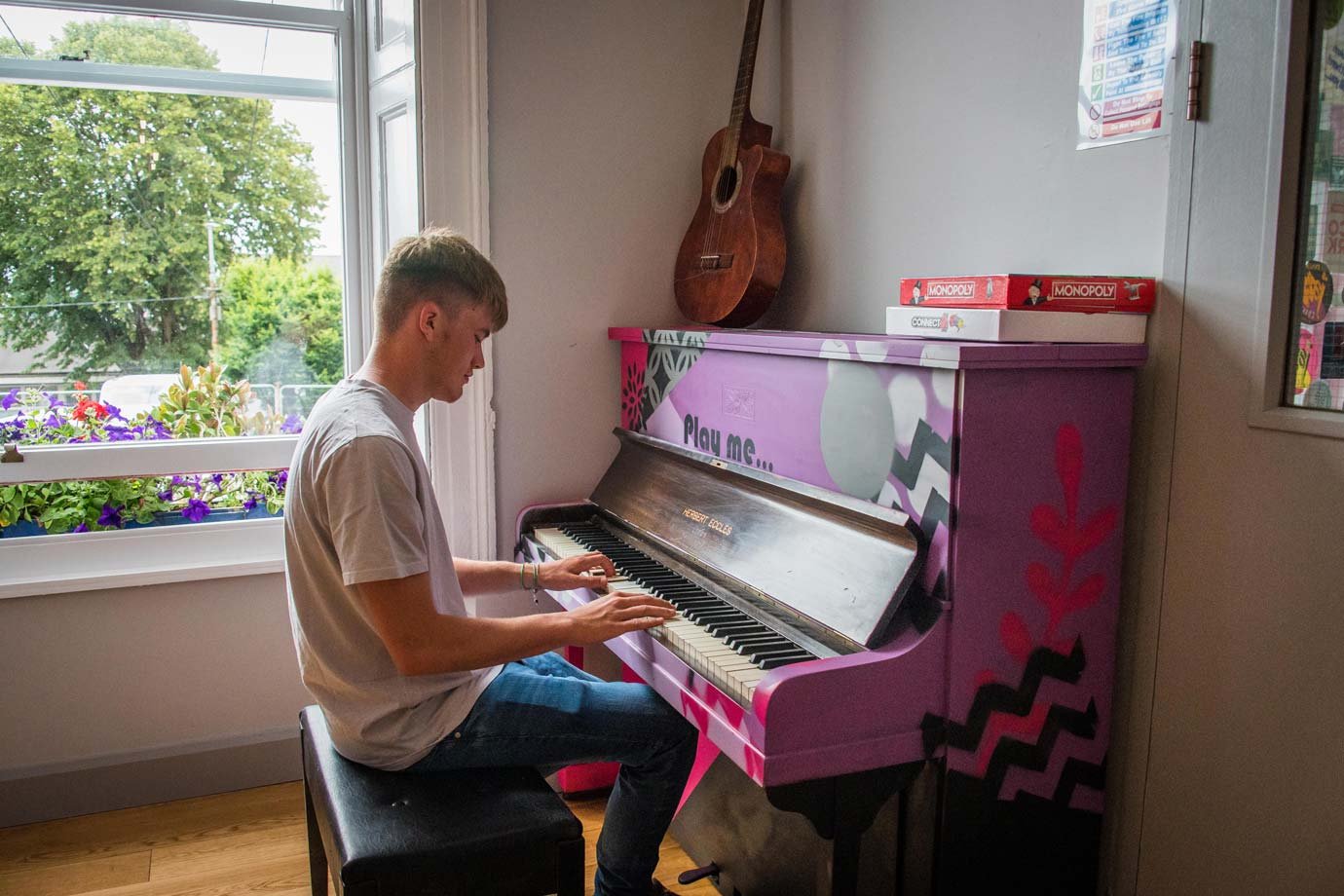 Student Playing Piano - Hostel Common Room