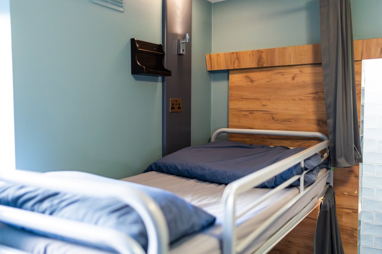 Multi-bedded dorm bunk bed with personal space (lamp, shelves and privacy curtain)