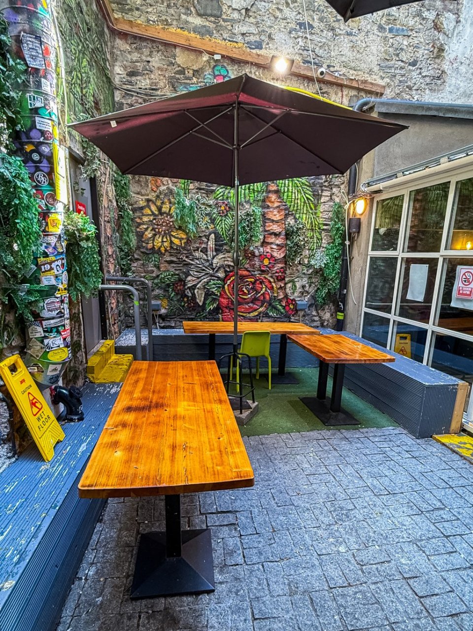 Garden Terrace with Murals and Tables in Hostel for Groups in Dublin