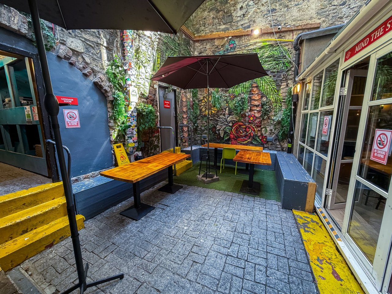 Abbey Court Hostel Dublin View of Colourful Outside Patio with benches and tables