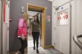 Tourist Residents Chatting Next to the Lift  in a Youth Hostel