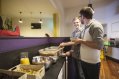 Tourist Residents Enjoying Continental Breakfast in Hostel