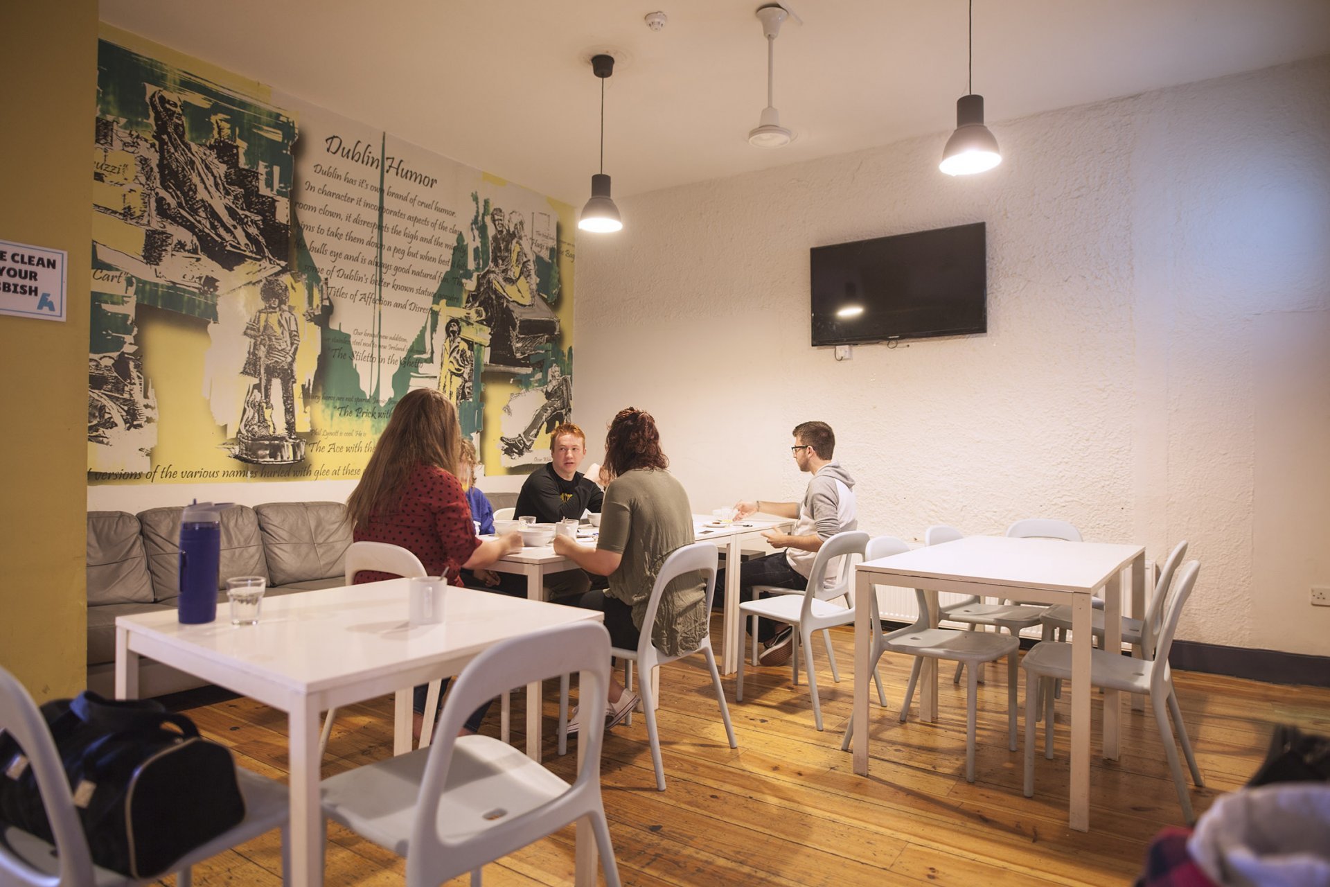 Group of Tourists Eating Breakfast in Hostel 's Eating Room