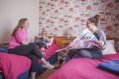 Tour Group Leaders on a Trip Planning Meeting in a Double Room in Hostel 