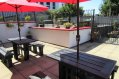 Red Umbrellas Picnic Tables - Hostel Patio Garden