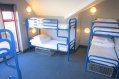 Three Bunk Bads in Student Hostel Room Blue Bad Frames