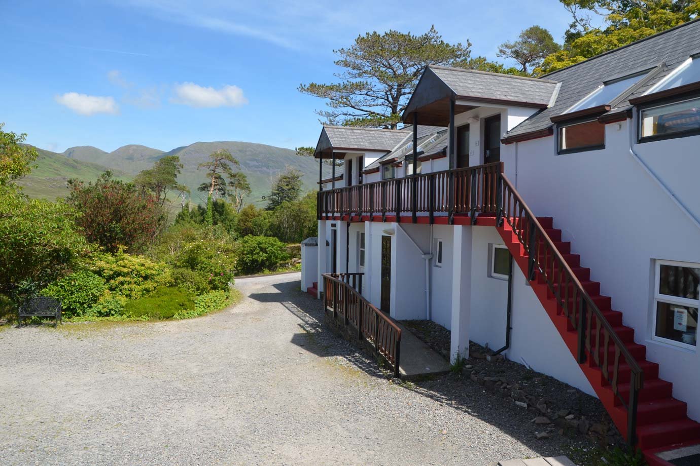 View of Connemara Hostel with Green Hills and Blue Sky on the Background