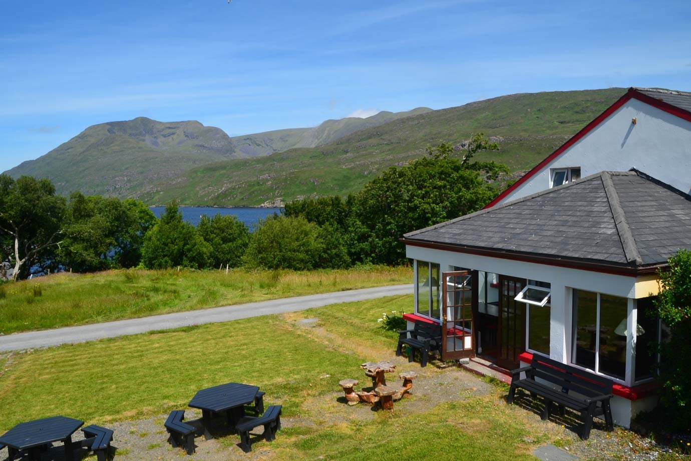 View of Green Connemara Hills With Blue Sky, Sea. Hostel with Picnic Table