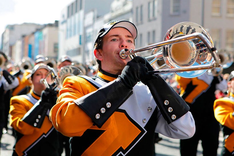 Musicians playing the trumpet on a marching parade 